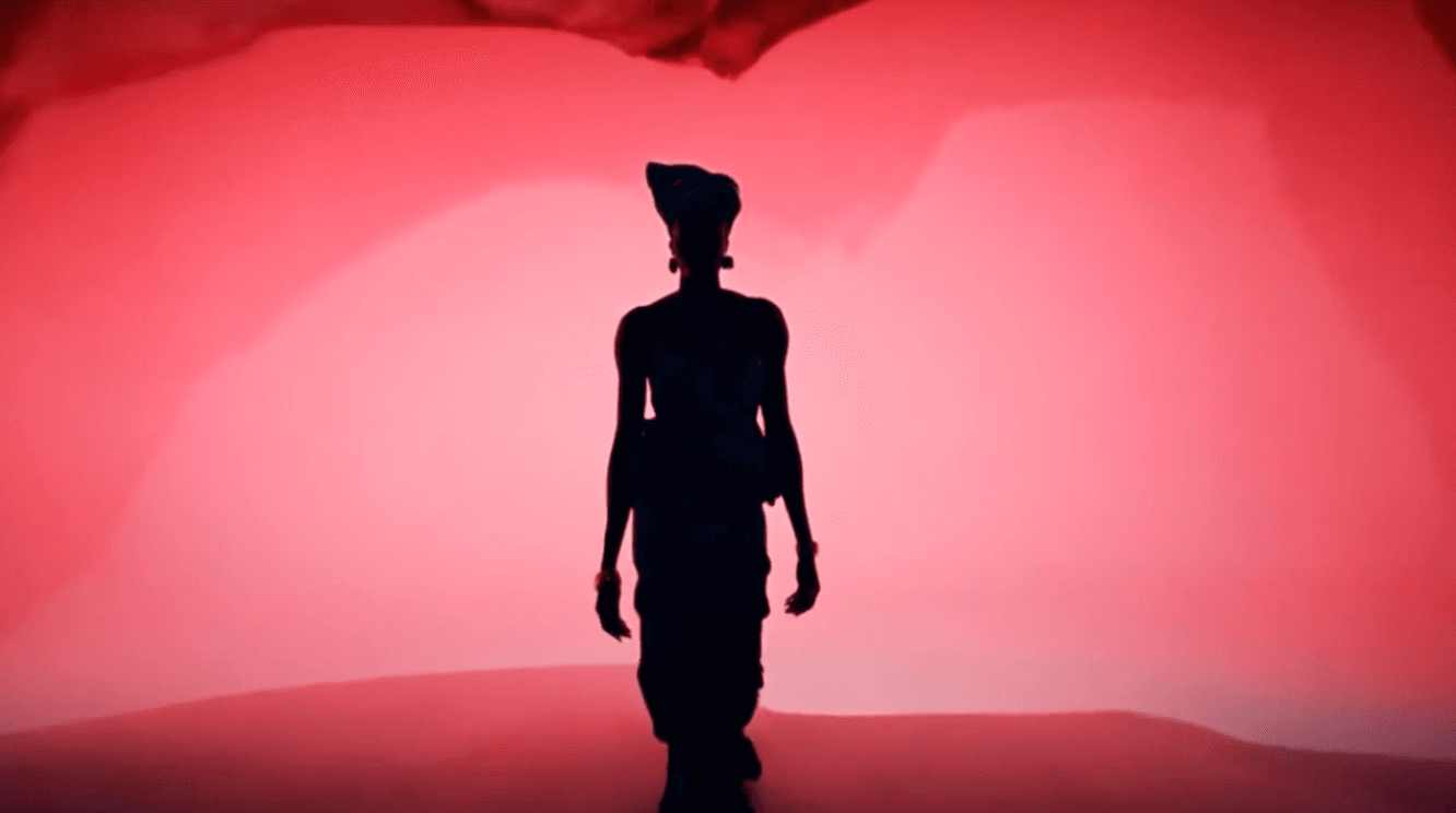 An African woman, fashion context, red hue backdrop